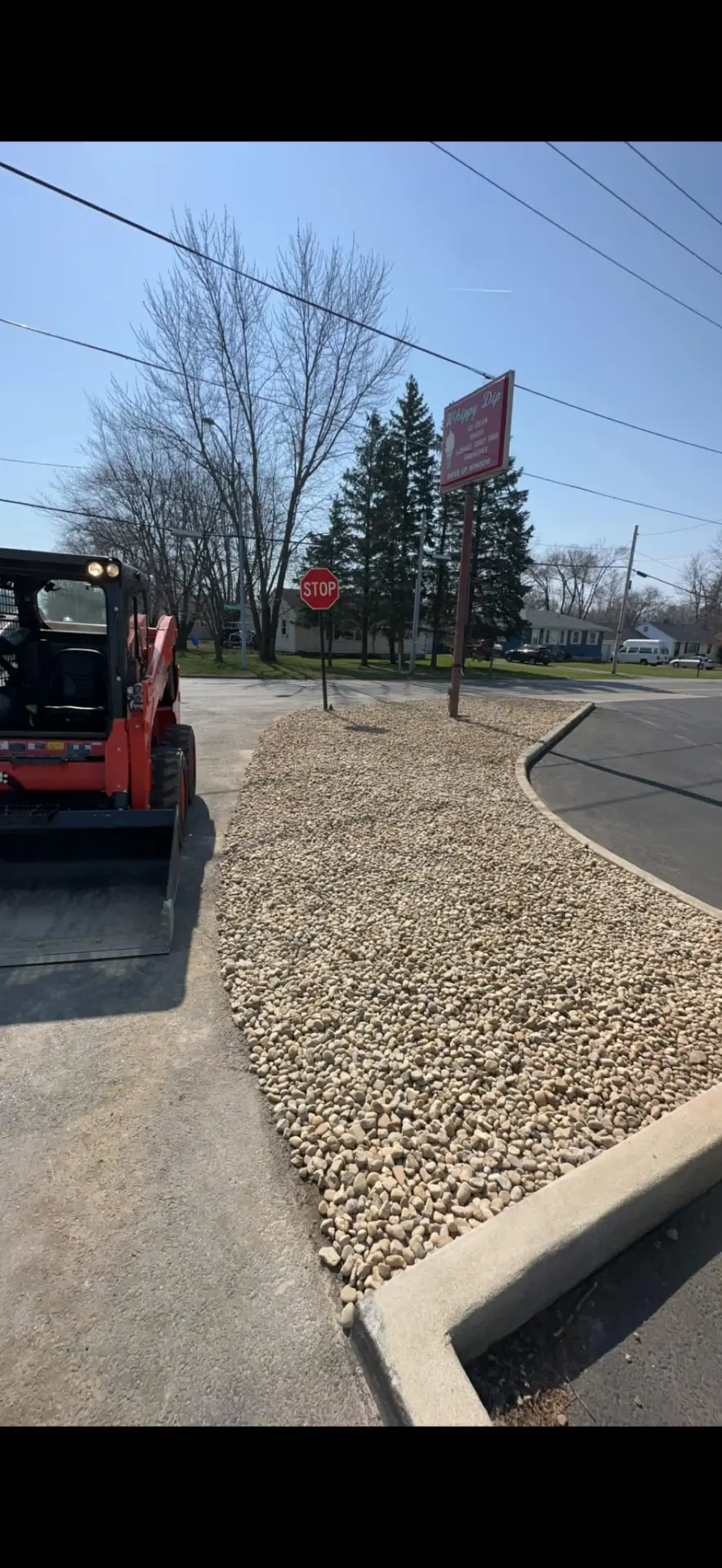 Completed gravel and curb work at a commercial corner lot